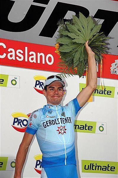 On the podium with the flowers.