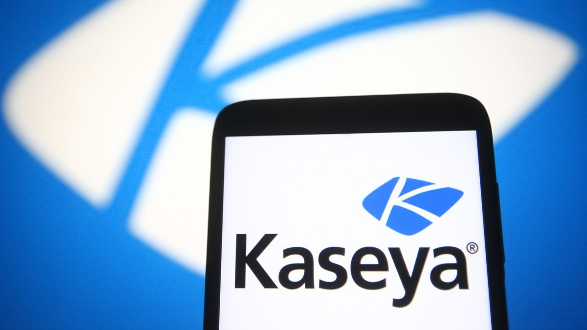 Kaseya&amp;#039;s logo appearing on a smartphone against a blue backdrop featuring a smaller Kaseya logo etched in white