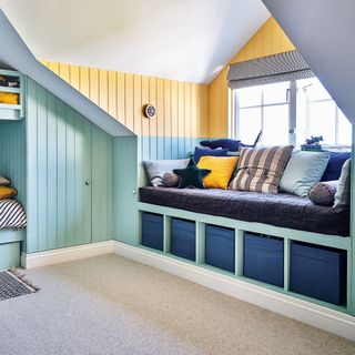 kids bedroom with wall panelling and window seat with built-in storage