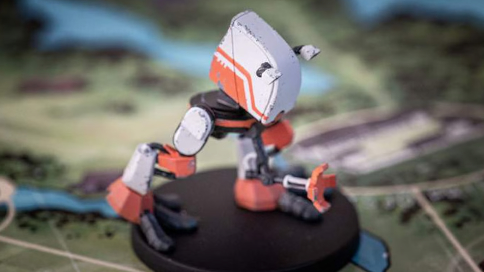 A robot miniature laid out on the Tales From the Loop - The Board Game board