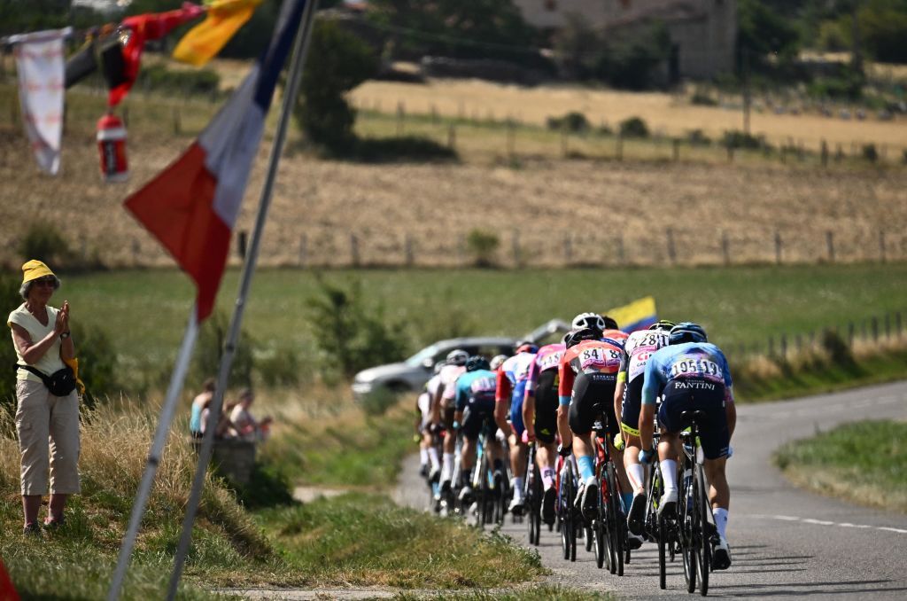 The pack of riders cycles during the 13th stage of the 109th edition of the Tour de France cycling race 1926 km between Le Bourg dOisans in the French Alps and SaintEtienne in central France on July 15 2022 Photo by Marco BERTORELLO AFP Photo by MARCO BERTORELLOAFP via Getty Images
