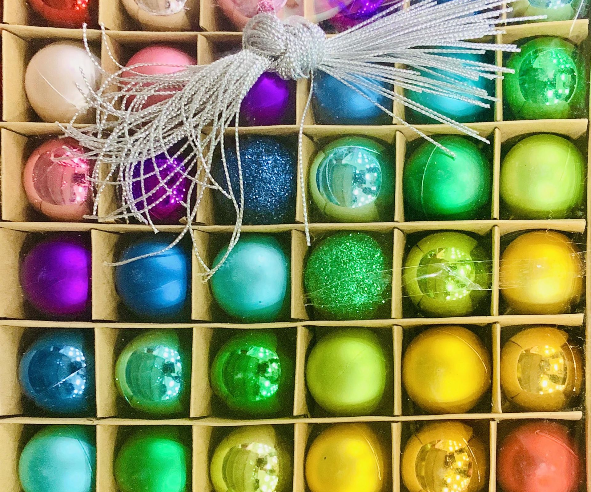 Rainbow baubles in a divided box