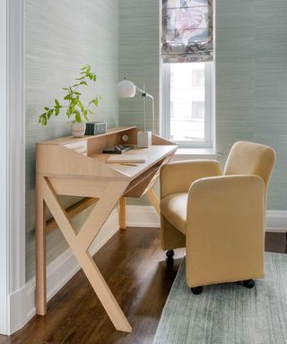 Pale blue home office with yellow chair and modern desk