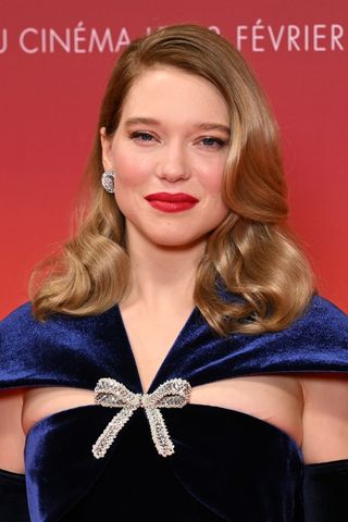 Léa Seydoux is pictured wearing red lipstick and a dark blue navy dress at the "Dune 2" Premiere at Le Grand Rex on February 12, 2024 in Paris, France.