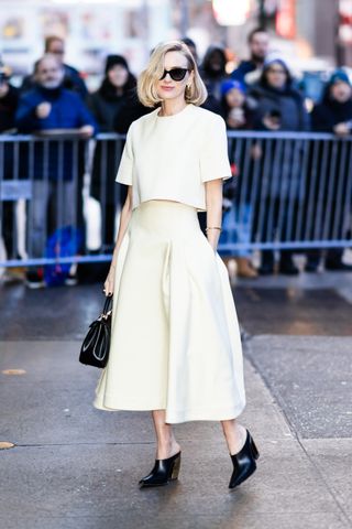 Naomi Watts wears a butter yellow two-piece.