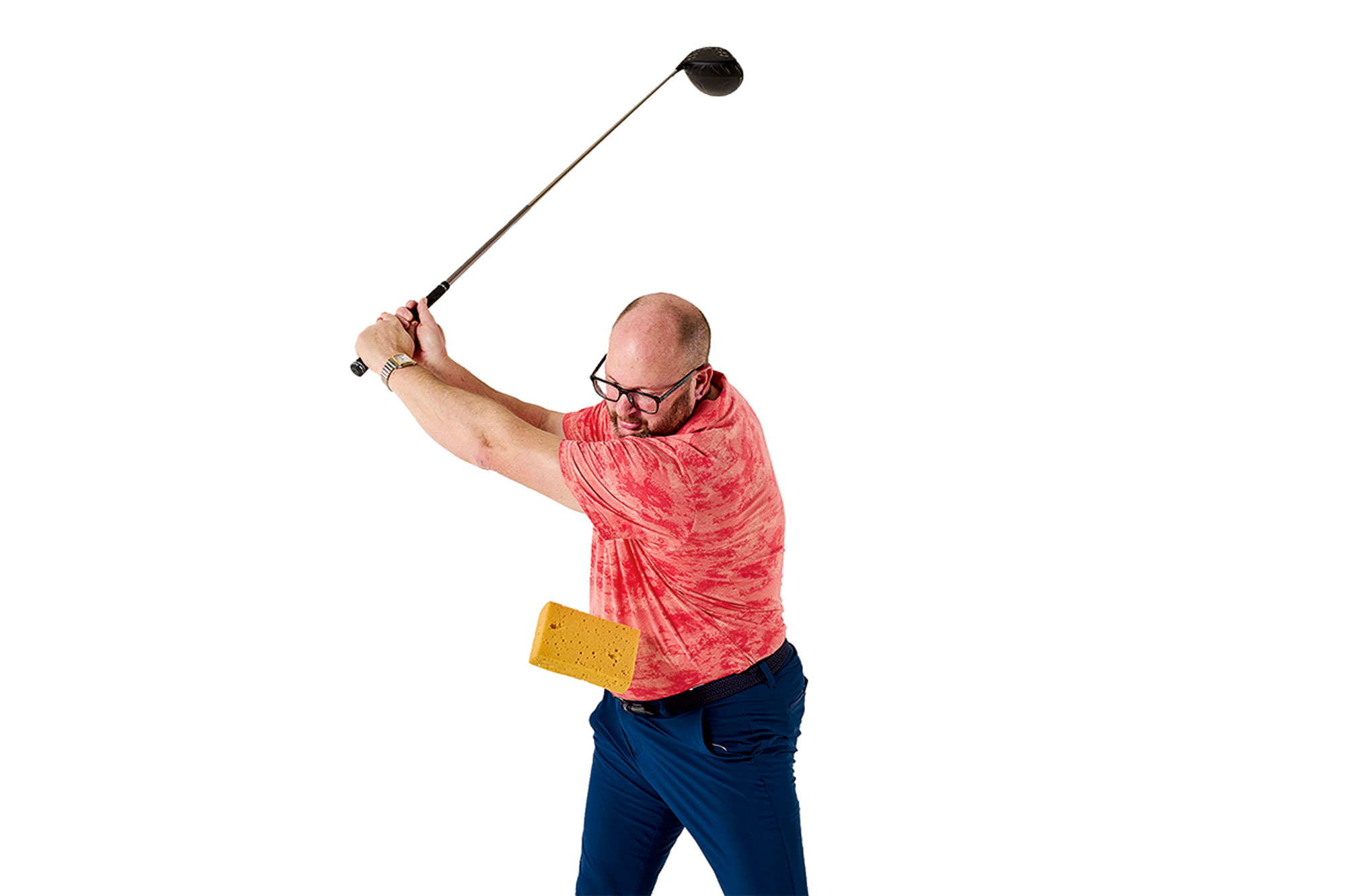 Russell Covey demonstrating what happens when the arms disconnect from the upper body in the golf swing, causing the sponge training aid to fall to the ground prior to impact