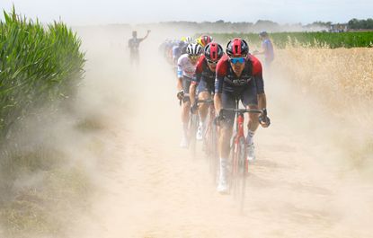 The peloton rides over a cobbled sector in the 2022 Tour de France