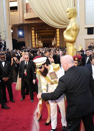 Actor Sacha Baron Cohen, dressed as his character 'General Aladeen,' arrives at the 84th Annual Academy Awards