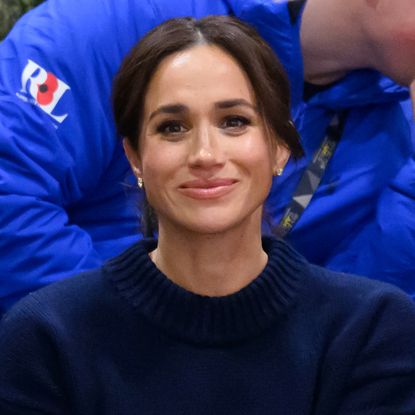 Meghan Markle wears a navy sweater at the Invictus Games 2025 where she joked about her character Rachel Zane from TV show Suits