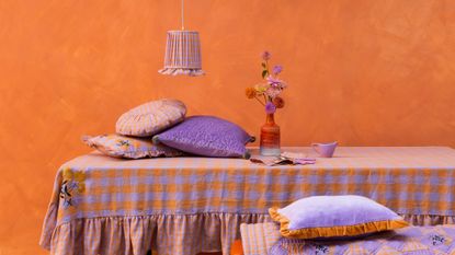 Table skirt in an orange painted room with soft furnishings