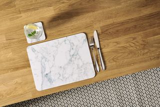 Dining table with marble-effect coasters and placemats