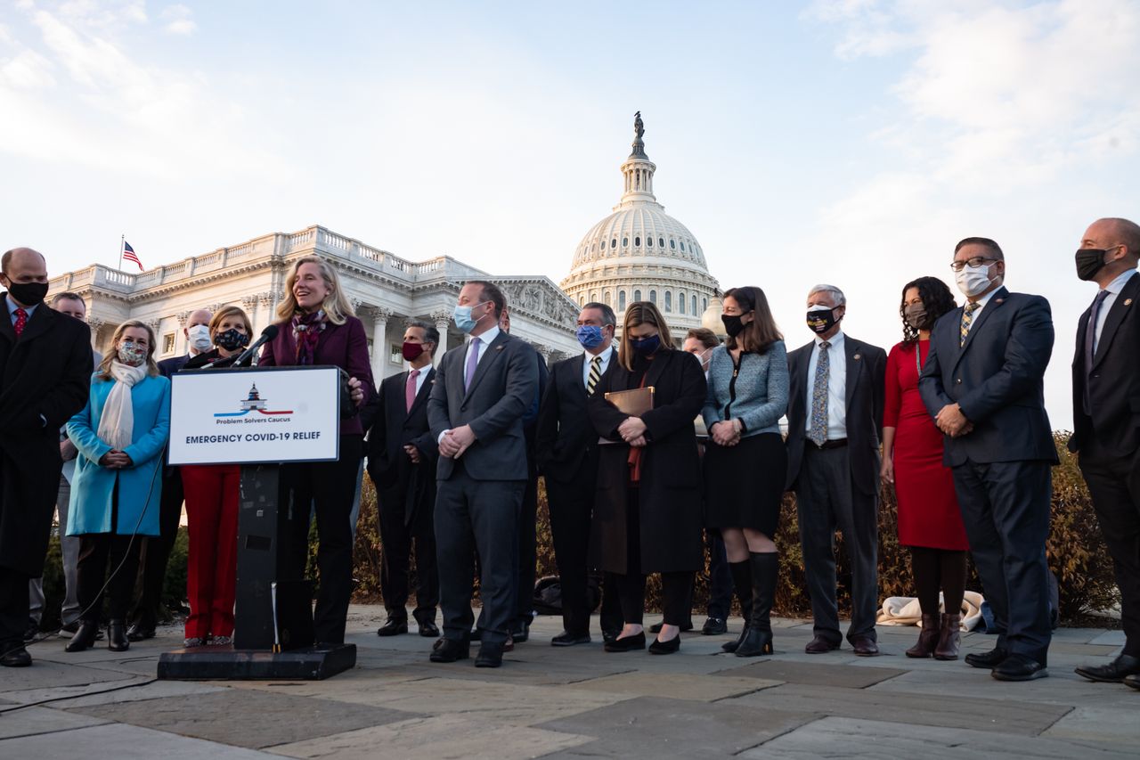 Bipartisan congressmembers celebrate passing a coronavirus relief bill.