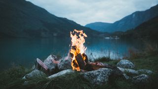 campfire safety: campfire in front of lake