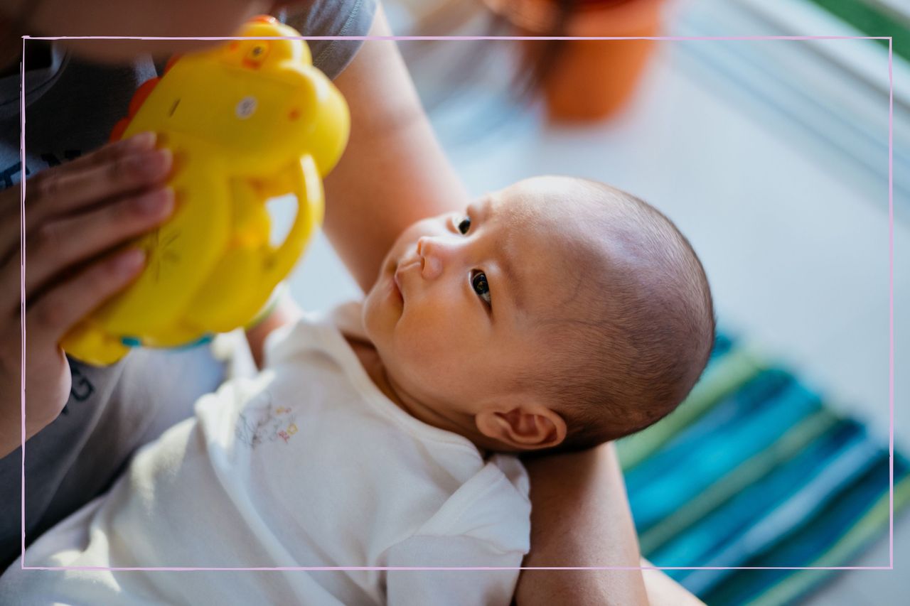 How to play with a newborn illustrated by a mother playing with her baby