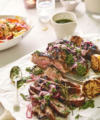 An example of barbecue recipes showing barbecued lamb with a mint dressing and lemon halves