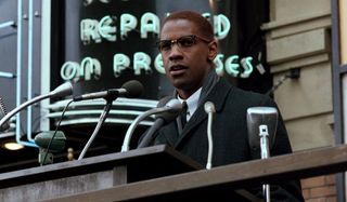 Malcolm X giving a speech outdoors
