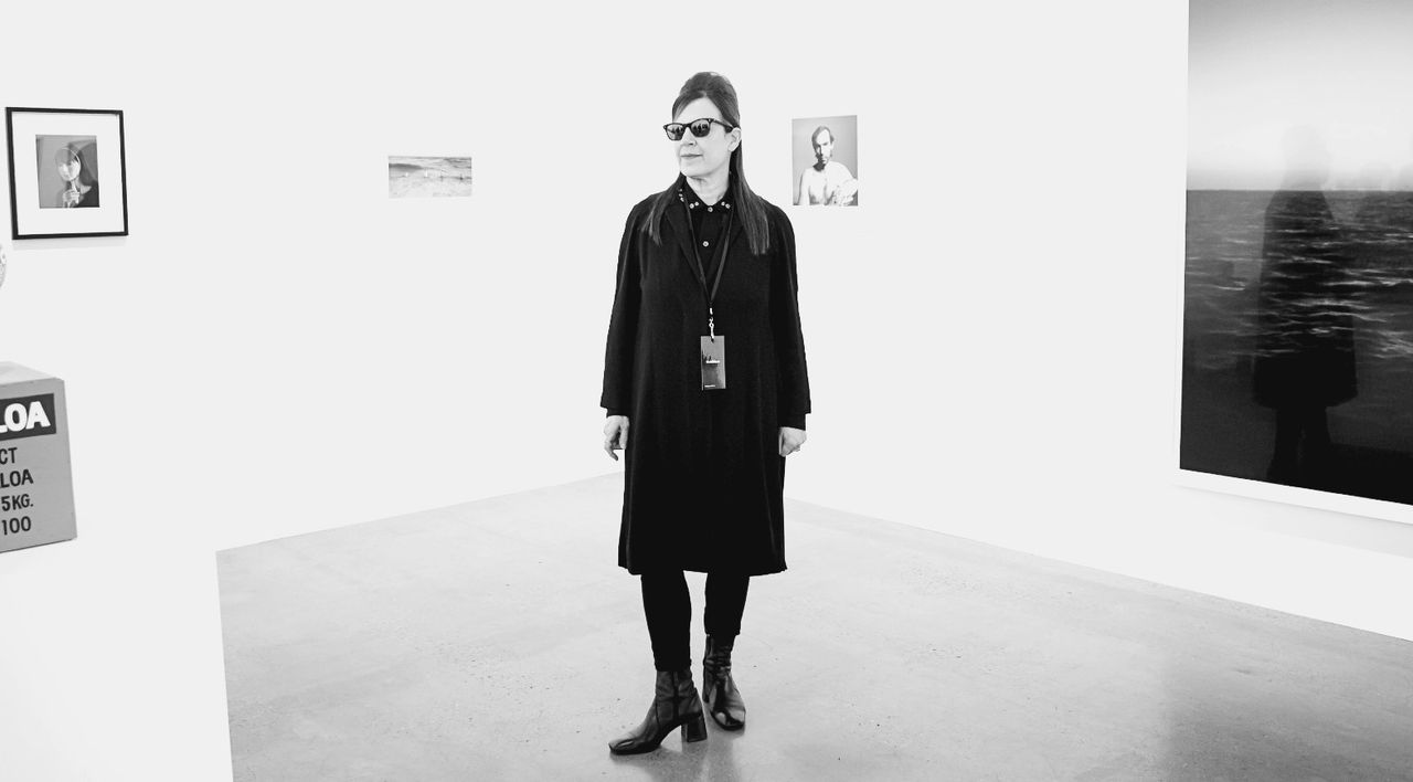 Maureen Paley stands in a gallery