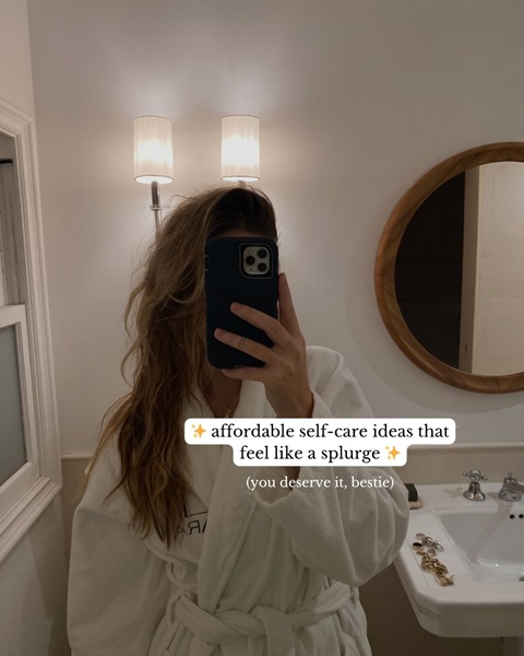 A photo of a woman taking a mirror selfie wearing a bath robe, with the text 'affordable self-care ideas that feel like a splurge' 