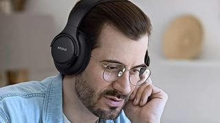 Man wearing KVideo Bluetooth Headphones.