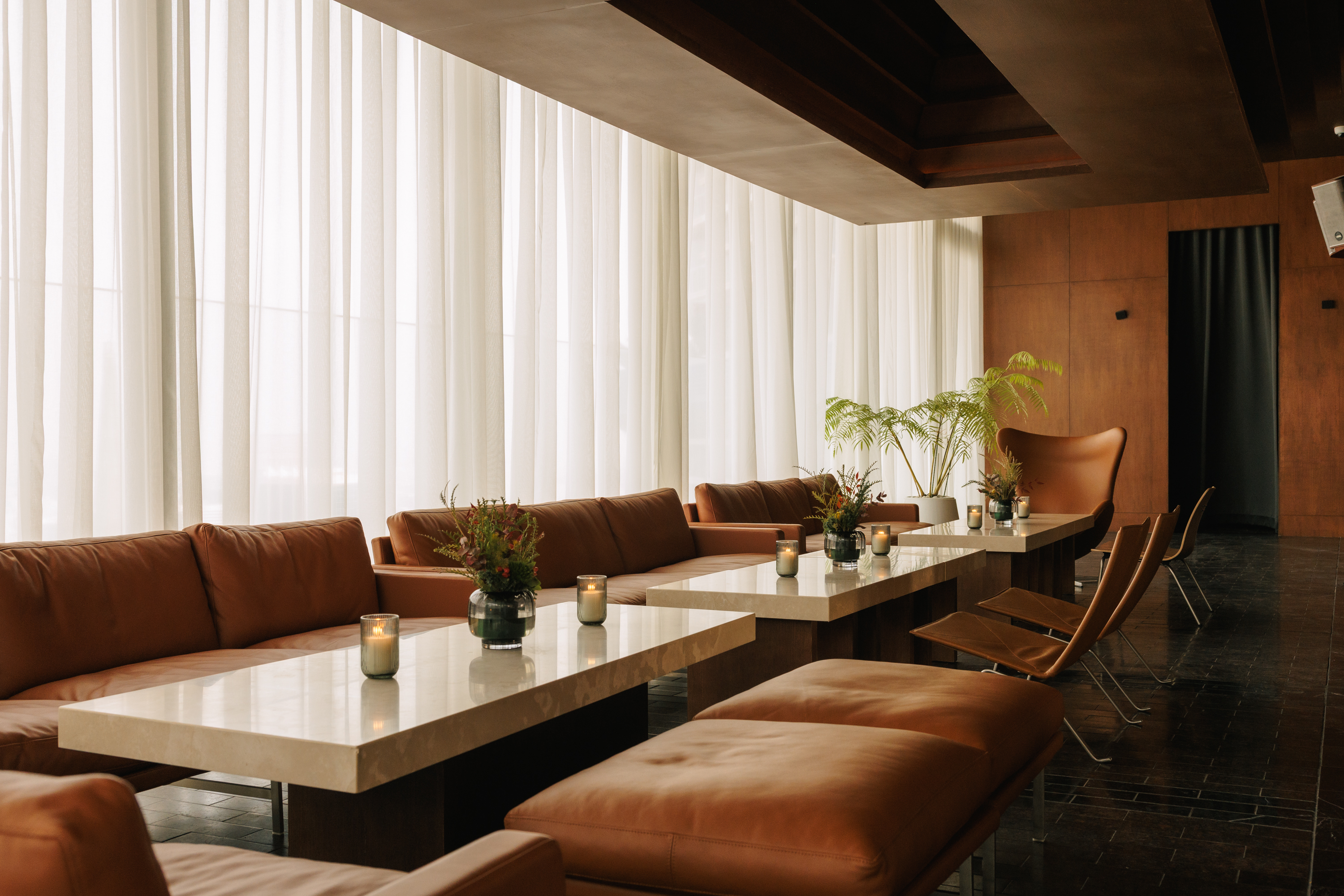 rooftop bar interior with warm wood and Fritz Hansen furniture