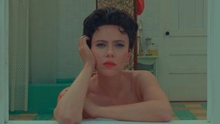 Scarlett Johansson sitting in a bathroom in Asteroid City