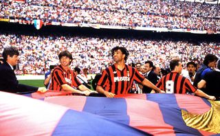 AC Milan players celebrate their Serie A title win by parading the club's flag at the end of the 1992/93 season.