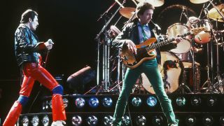Freddie Mercury (1946 - 1991) and musician John Deacon of British rock band Queen in concert, 1980. 