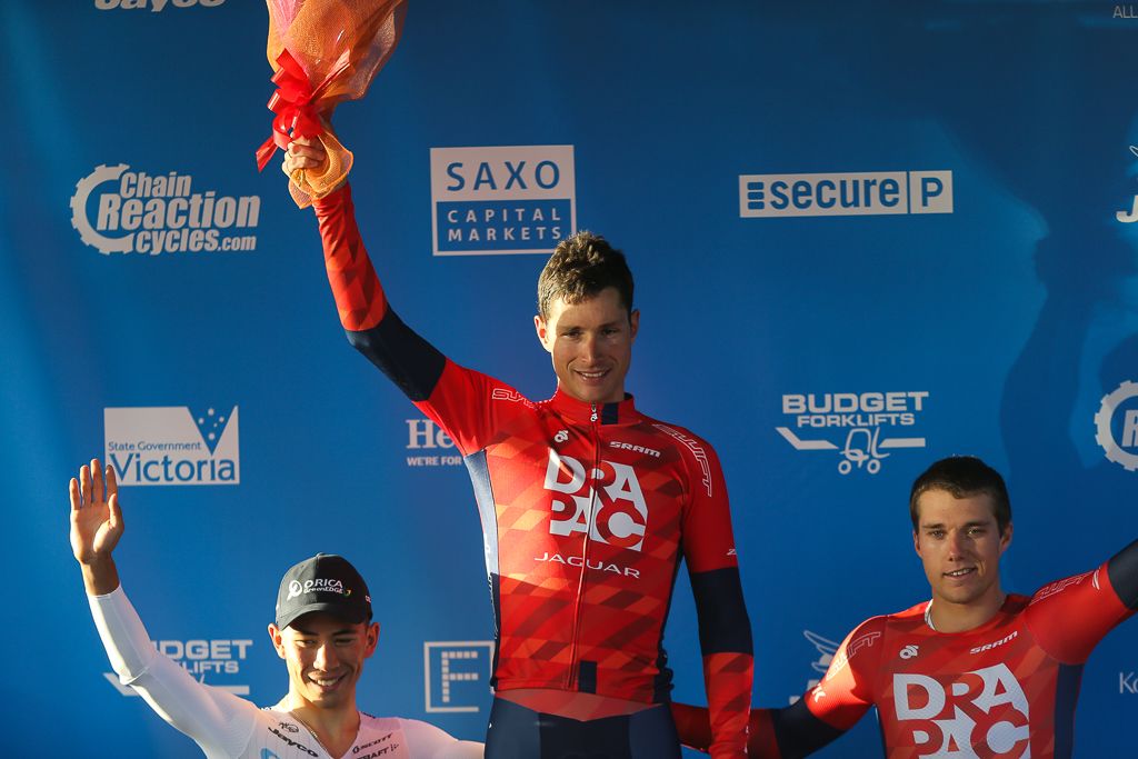Will Clarke stands on the top step