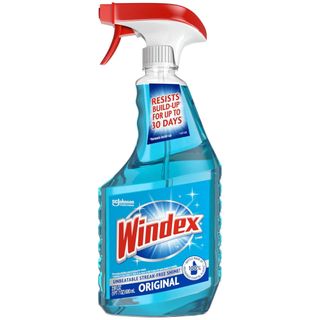 A side on view of a spray bottle of Windex blue cleaning solution with red logo and red and white spray lid