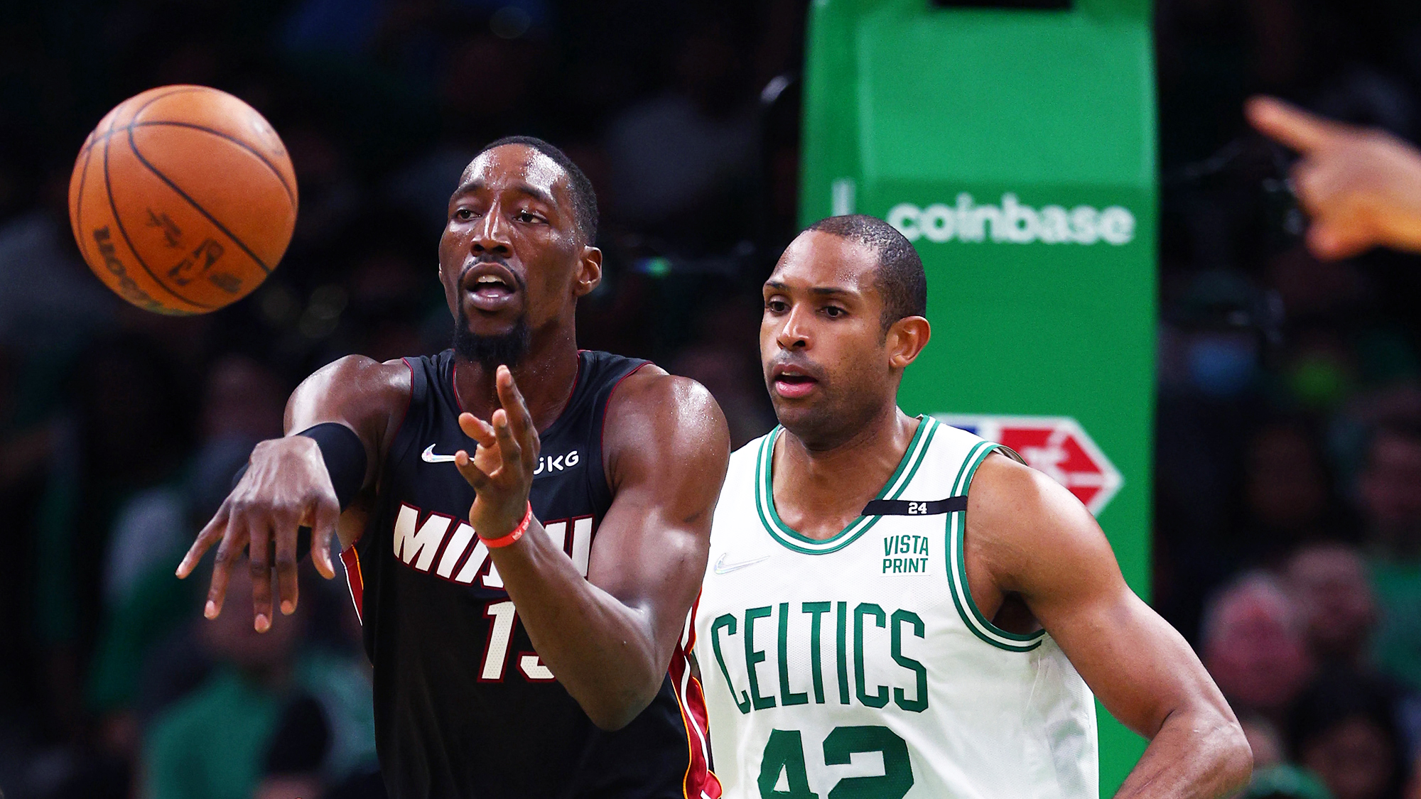 Bam Adebayo #13 of the Miami Heat passes in the second quarter against Al Horford #42 of the Boston Celtics