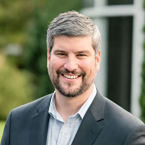 Head and shoulders of man smiling at camera