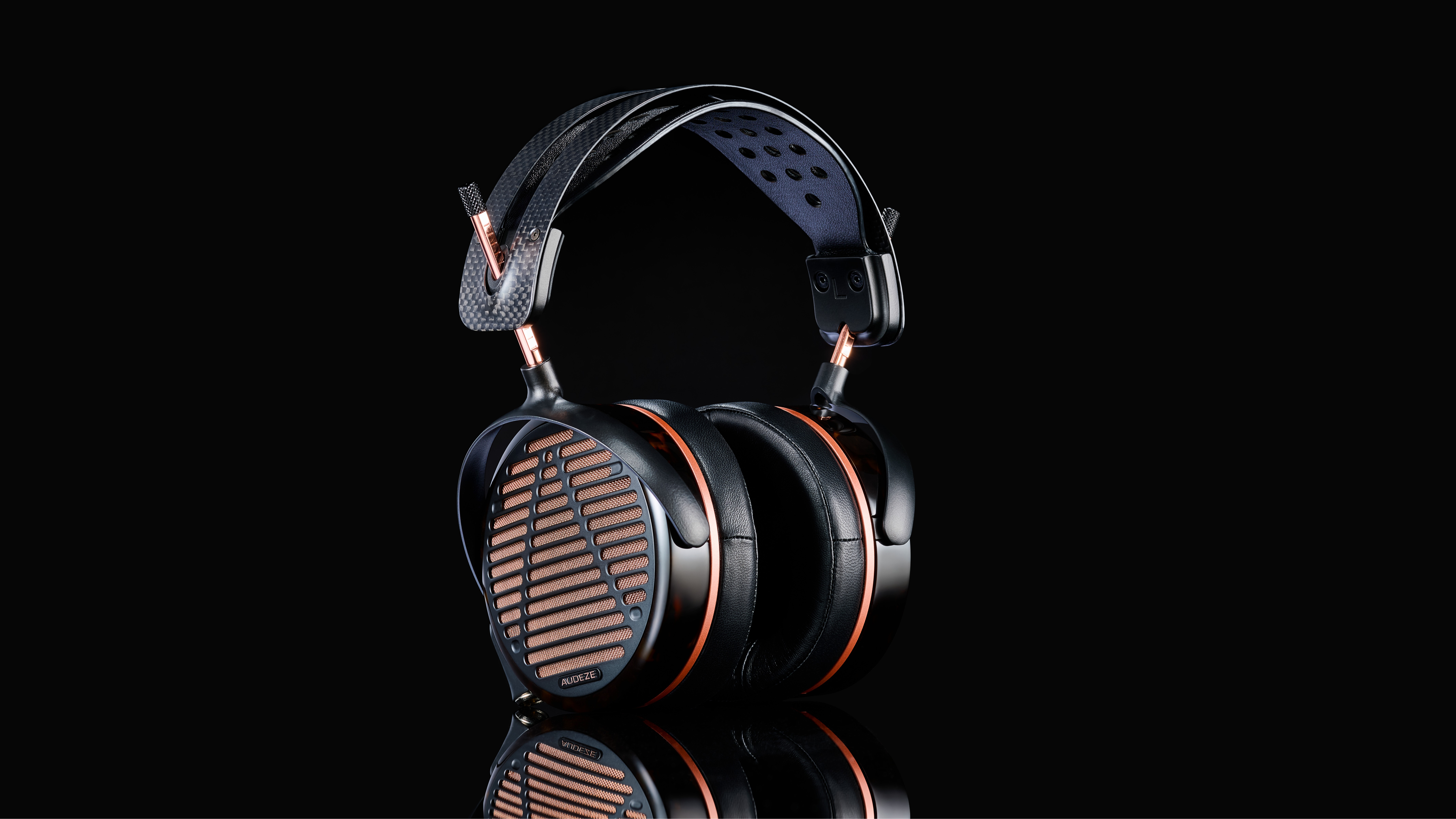 Audeze LCD-5s wired planar magnetic headphones on a black background