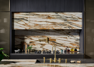 Perfectly bookmatched veined marble backsplash and matching cupboards above