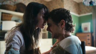 Alison Brie with head on Dave Franco's head in Together.