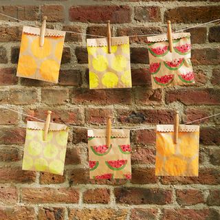 outside party with snack bag hanging on brick wall