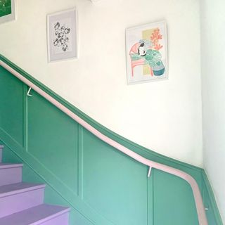 hallway with stairway and painting on wall
