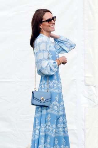 Catherine, Princess of Wales carries a blue handbag as she attends the Out-Sourcing Inc. Royal Charity Polo Cup 2023 at Guards Polo Club, Flemish Farm on July 6, 2023 in Windsor, England.