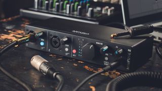 An Arturia MiniFuse 2 audio interface on a wooden table