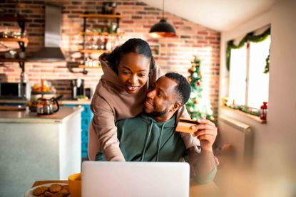 Close up of a young couple doing online Christmas shopping