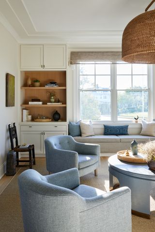 beach house white living room with blue armchairs