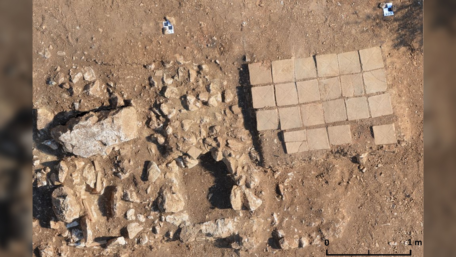 A photo of the cremation grave with bricks (right) next to two later graves (left).