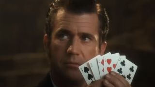 Mel Gibson holding a hand of cards in Maverick