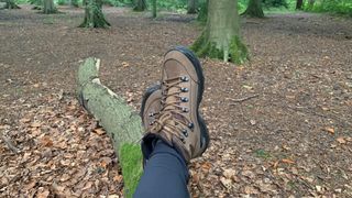 Sitting on a log in the forest wearing Low Renegade GTX boots