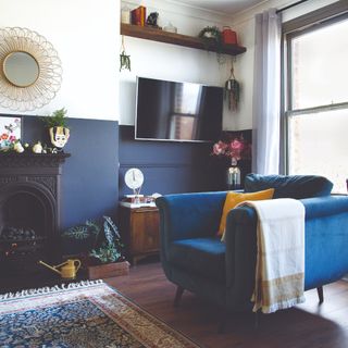 A living room with a blue armchair and a TV