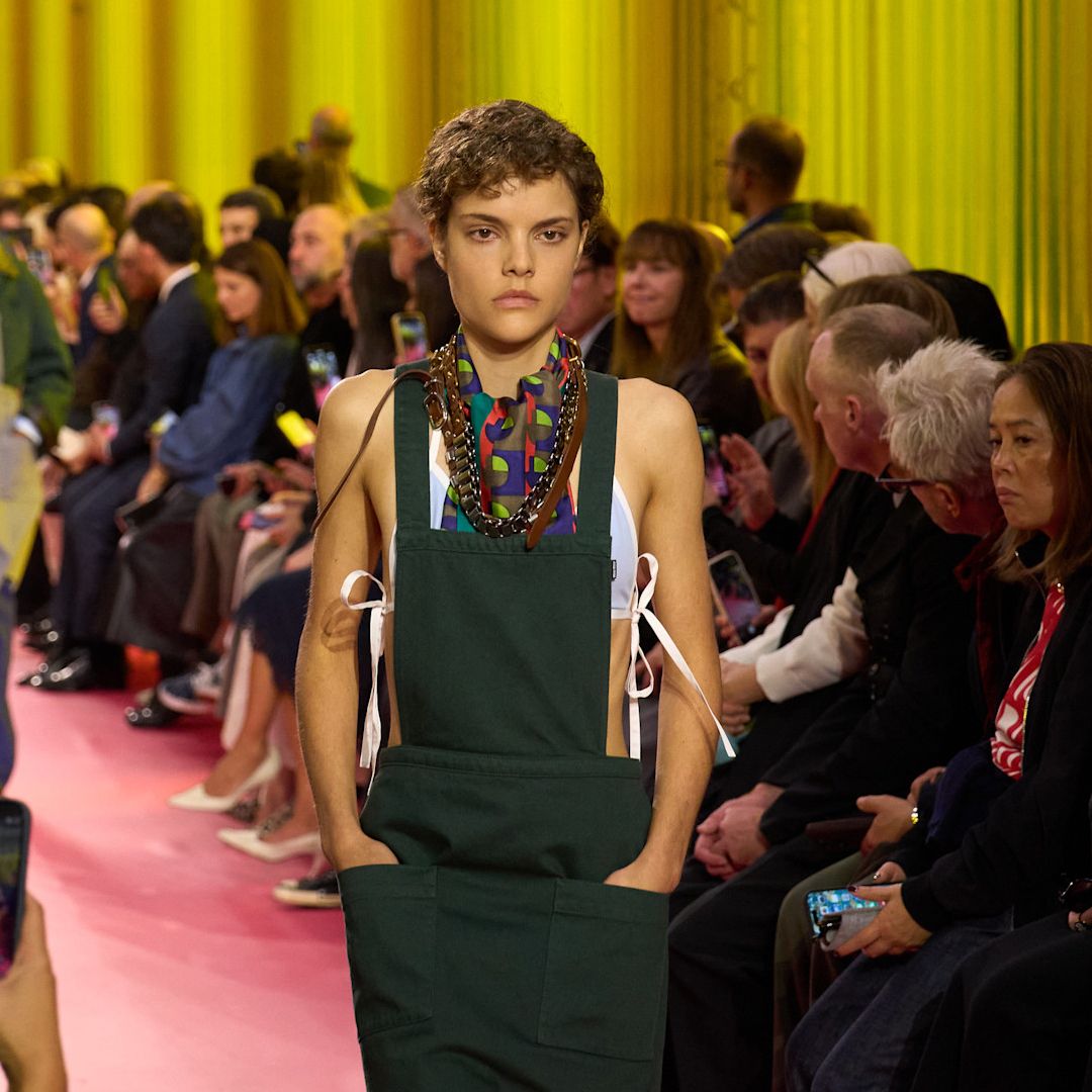 a model on the Paris Spring 2026 runway wearing a pocketed apron by Miu Miu