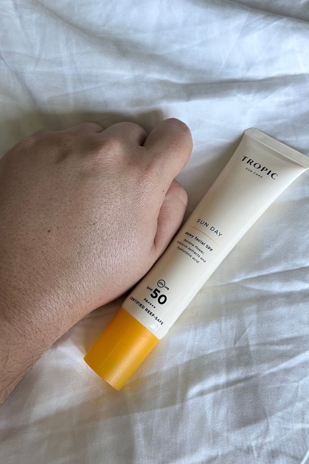 swatch of tropic spf and bottle