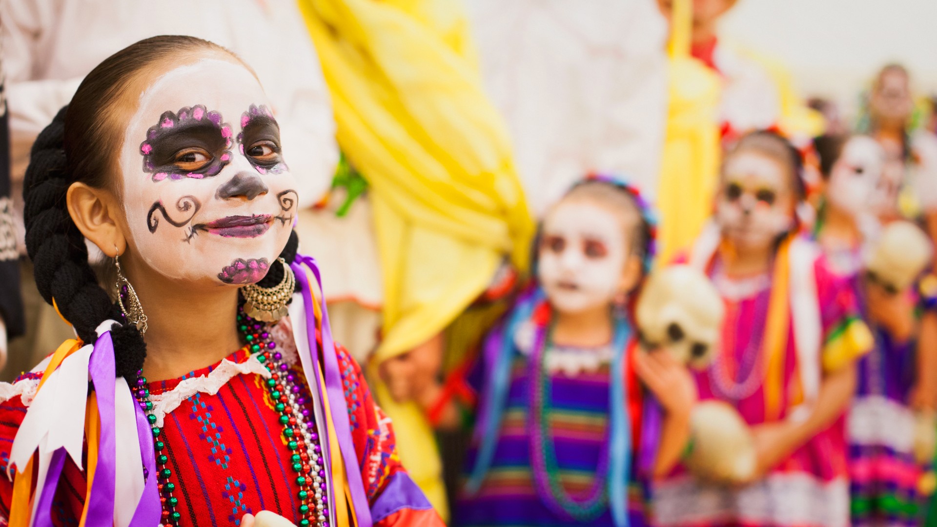Children in traditional dress for Dia de los Muertos