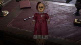 A screenshot of a creepy doll from Sherlock Holmes: The Awakened.