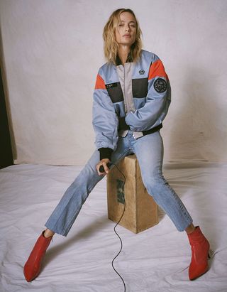 Model wearing blue jacket, pant and brown boots