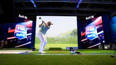 Shane Lowry hits a drive inside SoFi Center during a TGL match in 2025